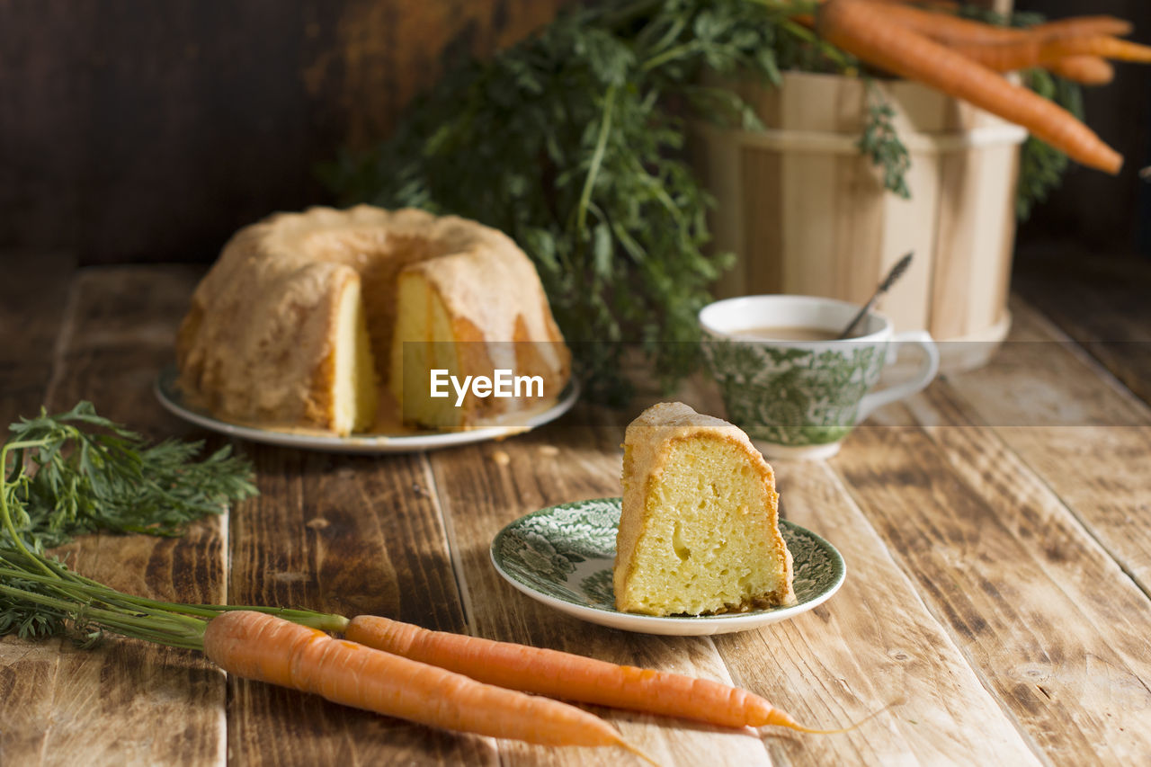 Sugar glazed carrot cake, homemade baked goods, rustic still life, national carrot cake day, cup 