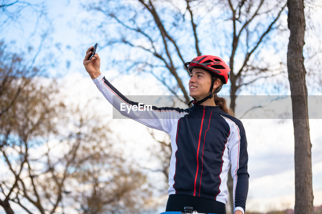 Male athlete taking selfie while standing park