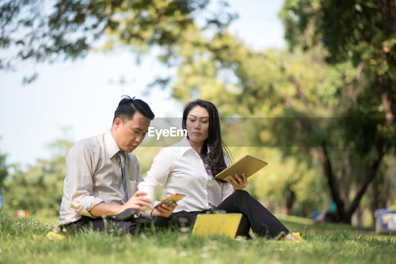 Business people working in park