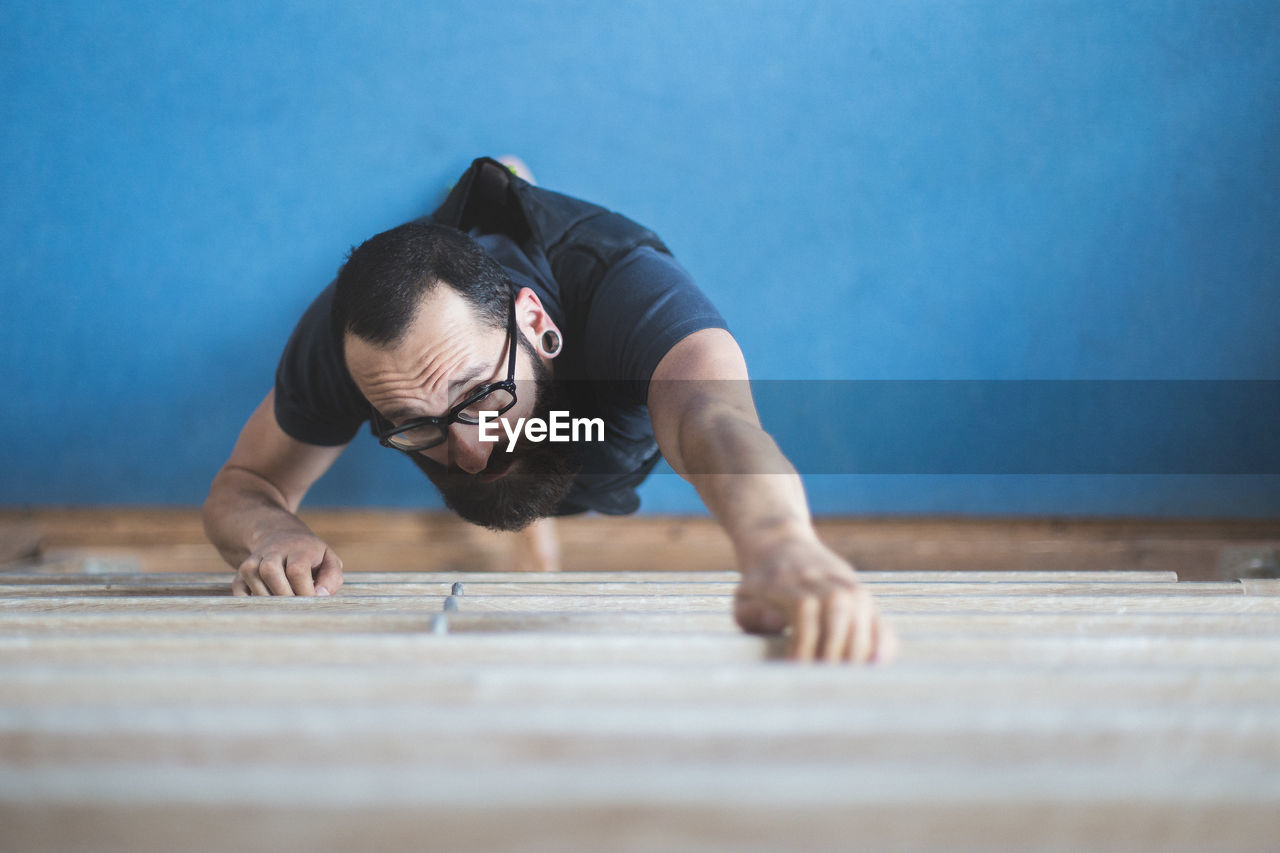 High angle view of man climbing in gym