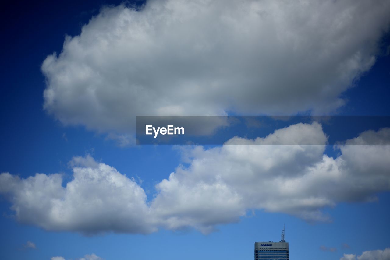 sky, cloud, architecture, horizon, built structure, blue, building exterior, cloudscape, nature, building, no people, sunlight, city, outdoors, daytime, day, environment, low angle view, dusk, storm, tower, beauty in nature, dramatic sky, storm cloud