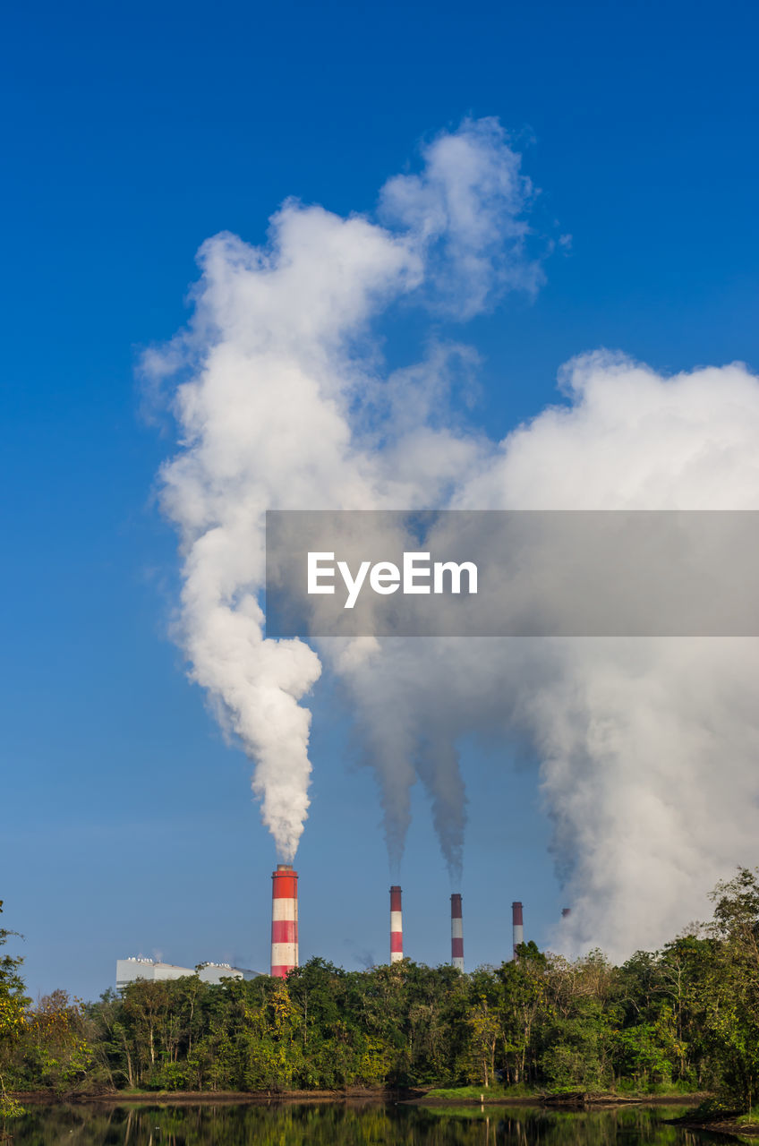 Smoke emitting from chimney against sky, coal power plant