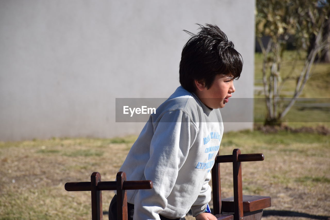 Boy sitting on bench