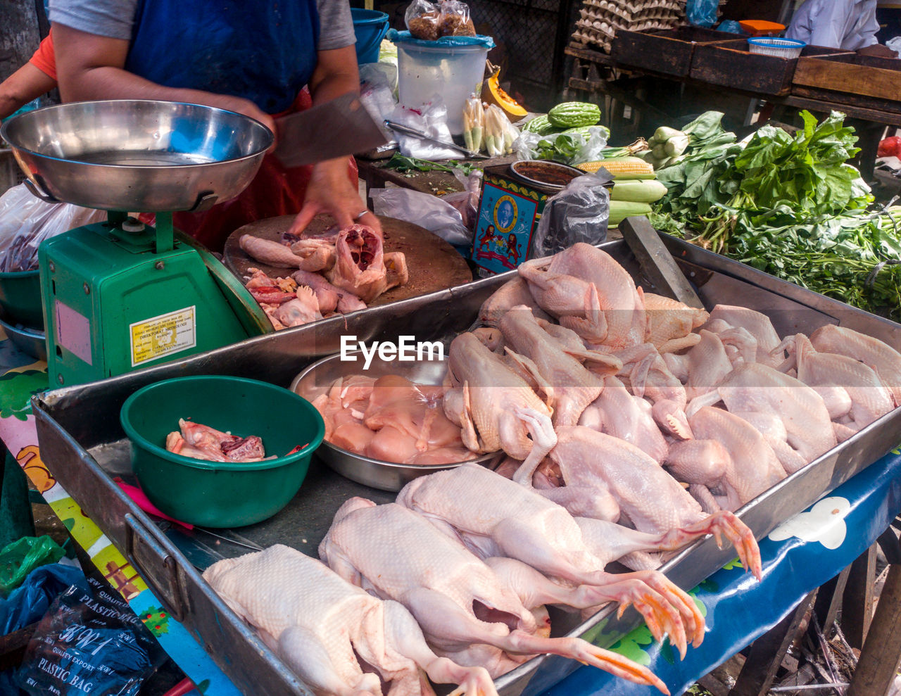 MAN PREPARING FISH IN MARKET