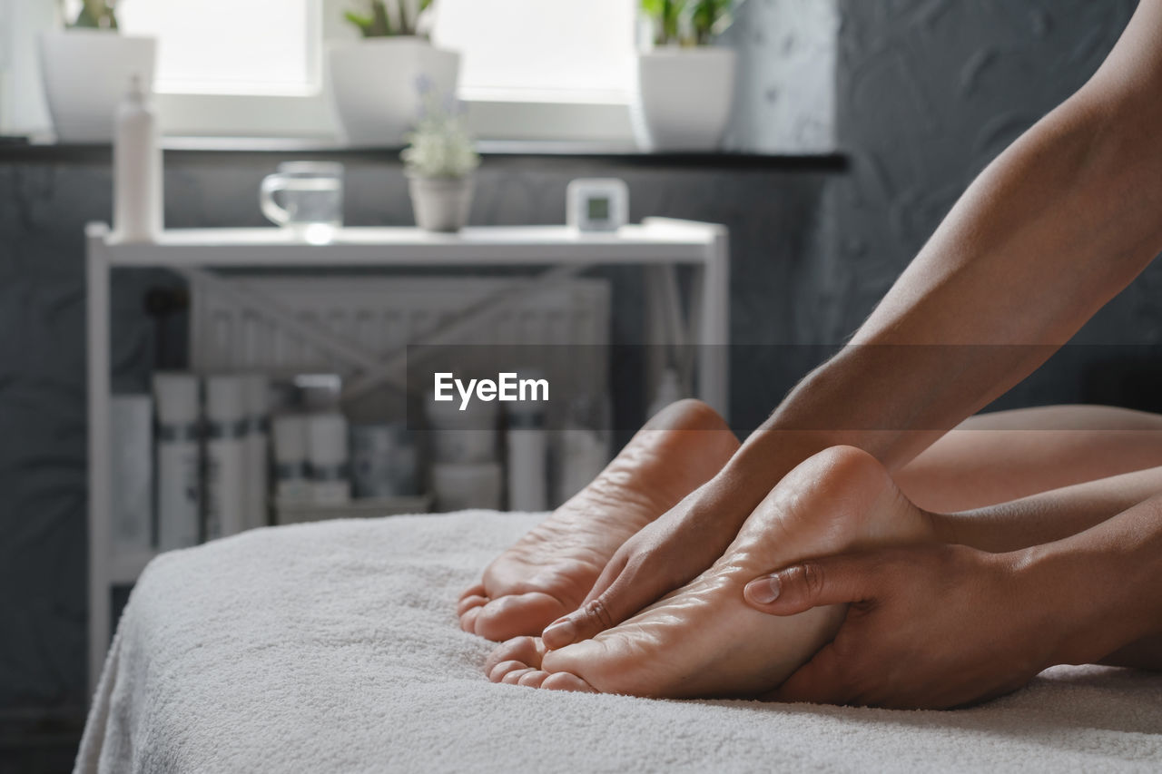 Woman foot spa massage treatment by professional massage therapist in spa resort. wellness