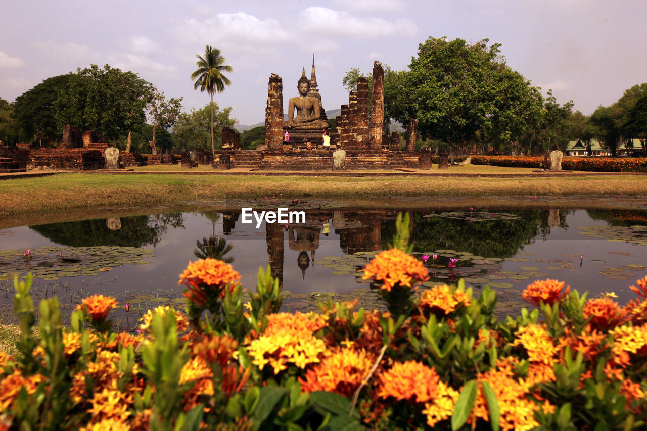 TEMPLE BY LAKE AGAINST SKY