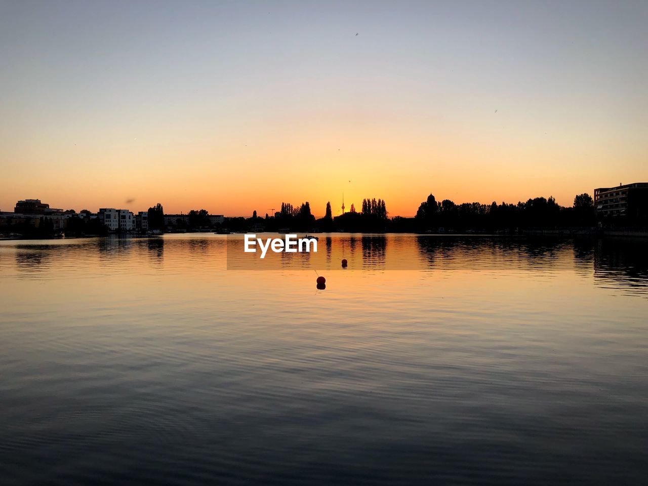 Scenic view of lake against sky during sunset