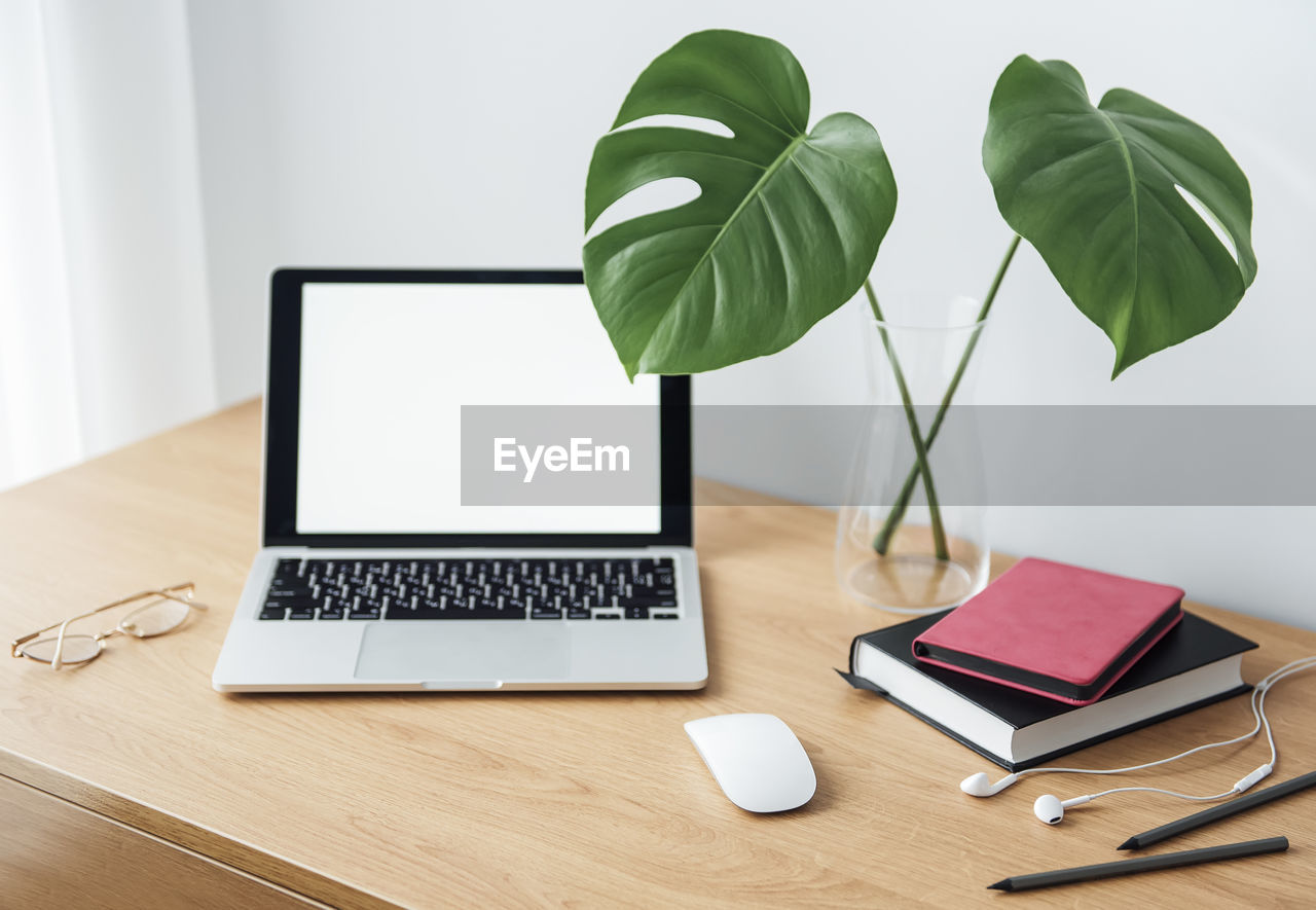 Office workplace with laptop on wooden table