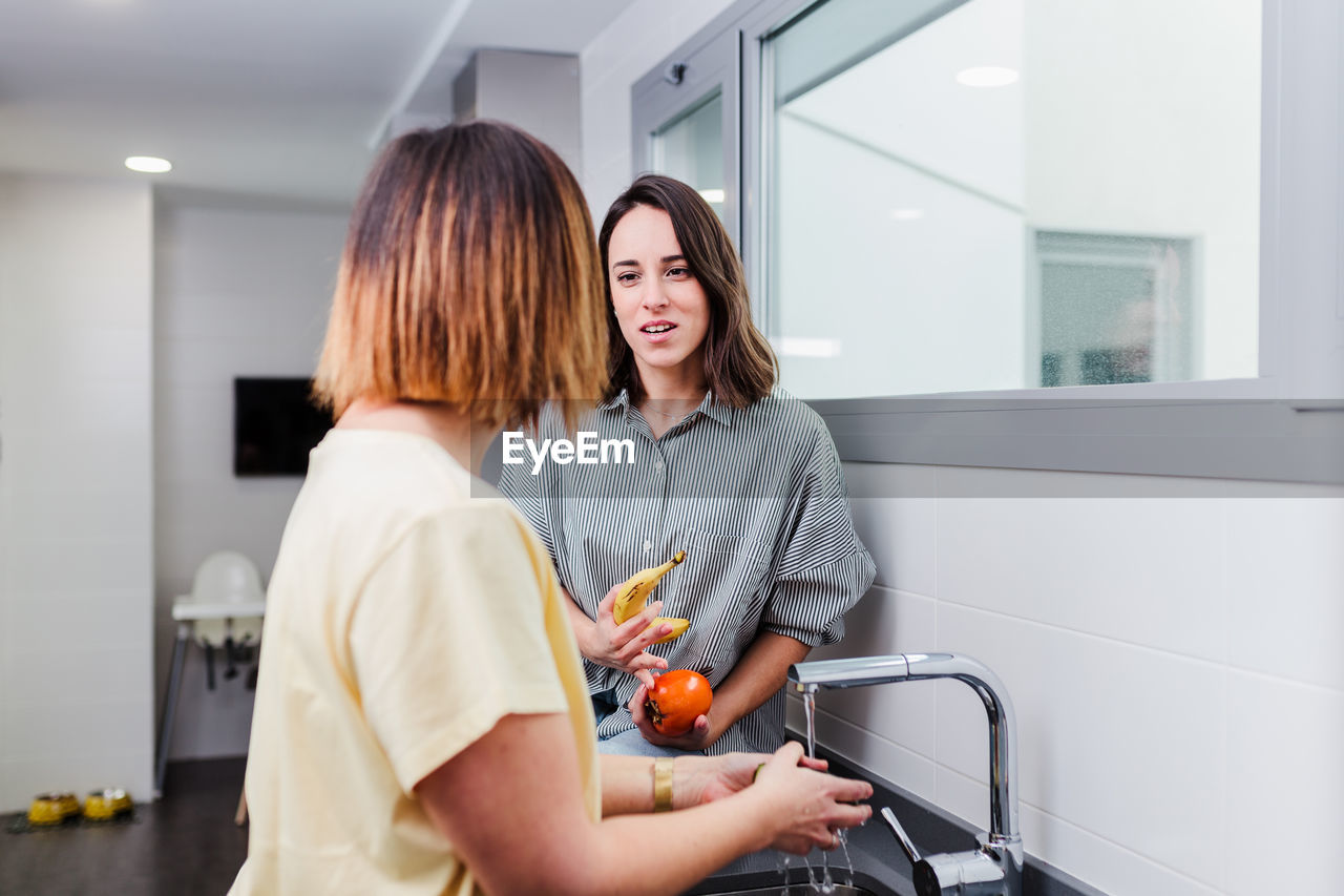 Women preparing food at kitchen