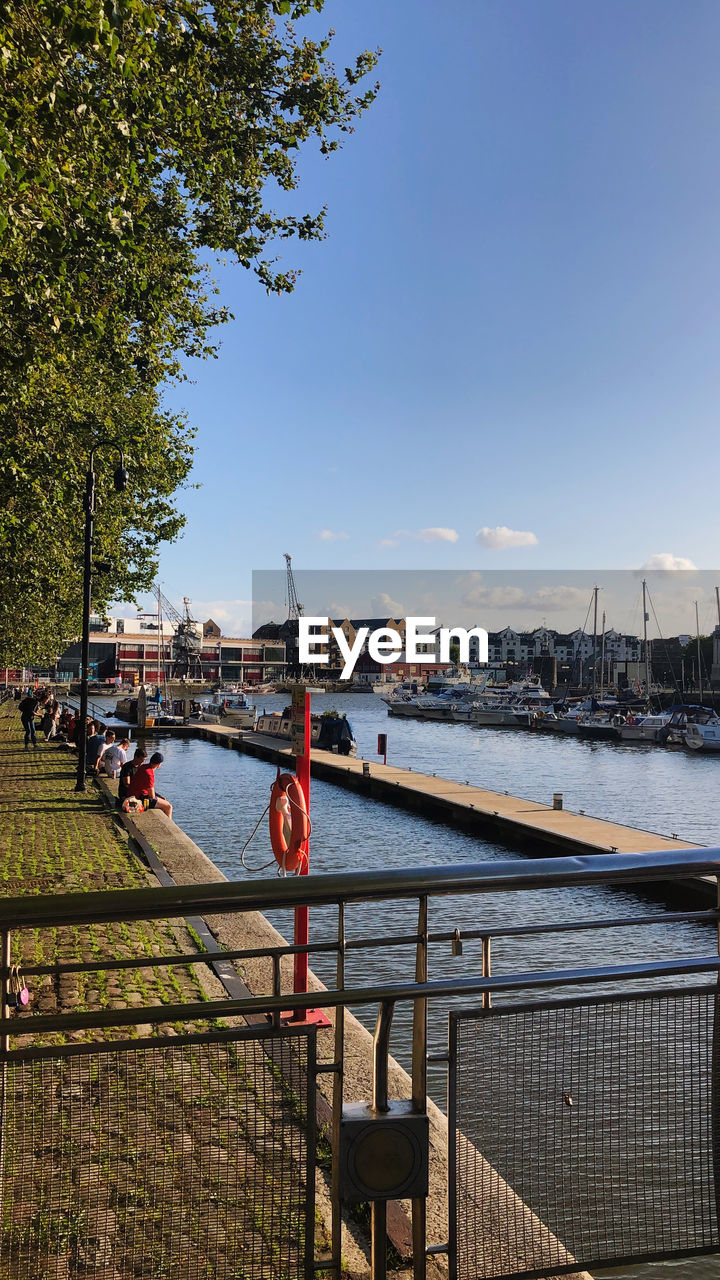 Scenic view of river by city against sky