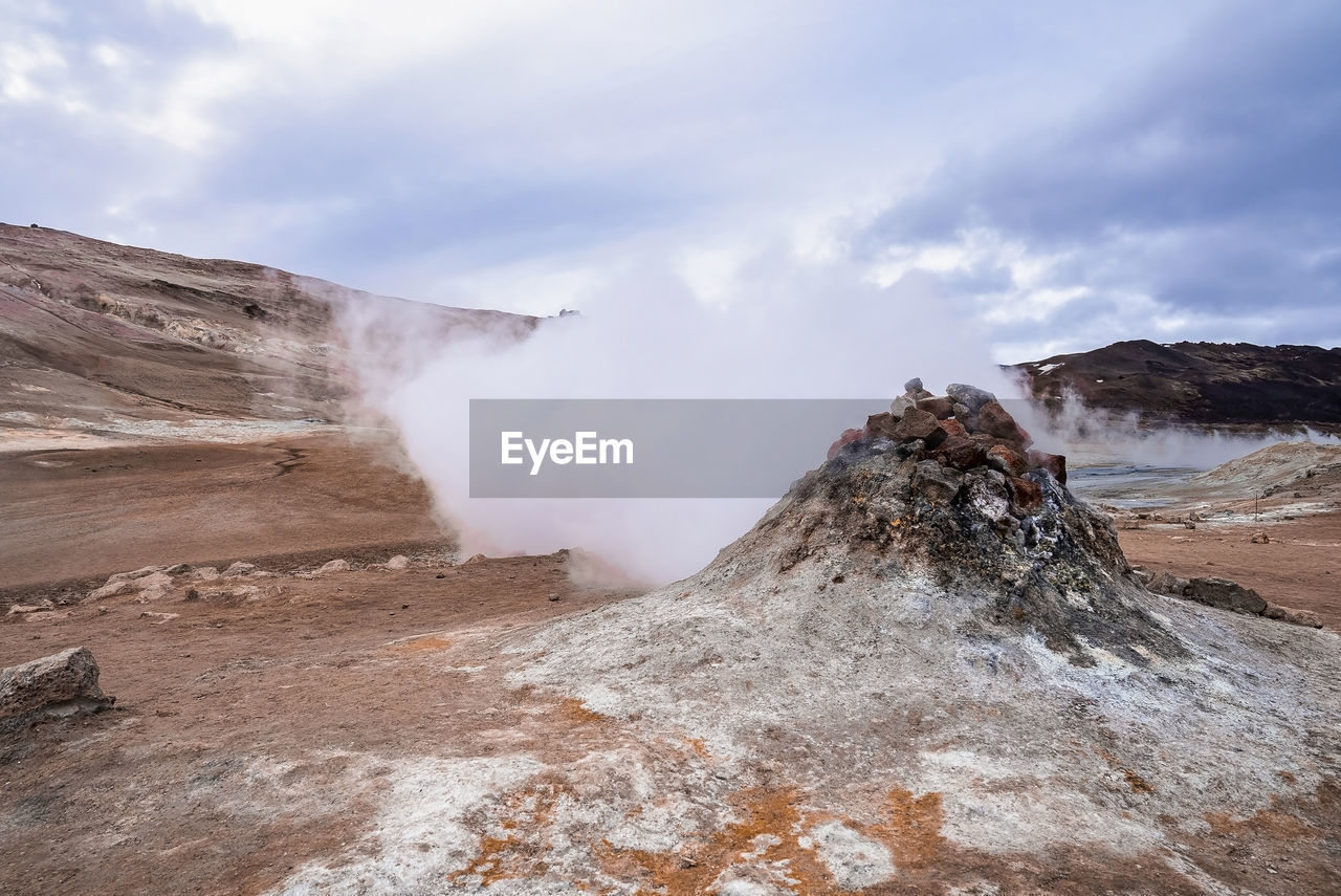 View of steam emitting from fumarole in geothermal area of hverir at namafjall