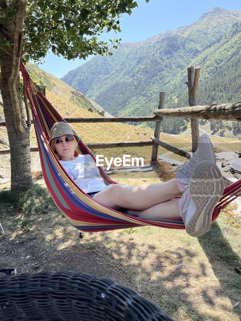 day, nature, hammock, leisure activity, one person, sunlight, lifestyles, spring, tree, women, casual clothing, adult, hanging, outdoors, playground, plant, full length, rope, childhood, low angle view, adventure, female, clothing, child, young adult, person, men, architecture