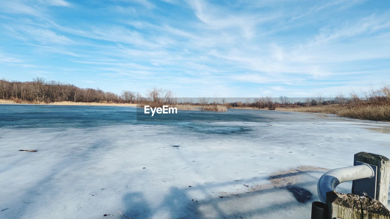 Scenic view of snow covered field against sky