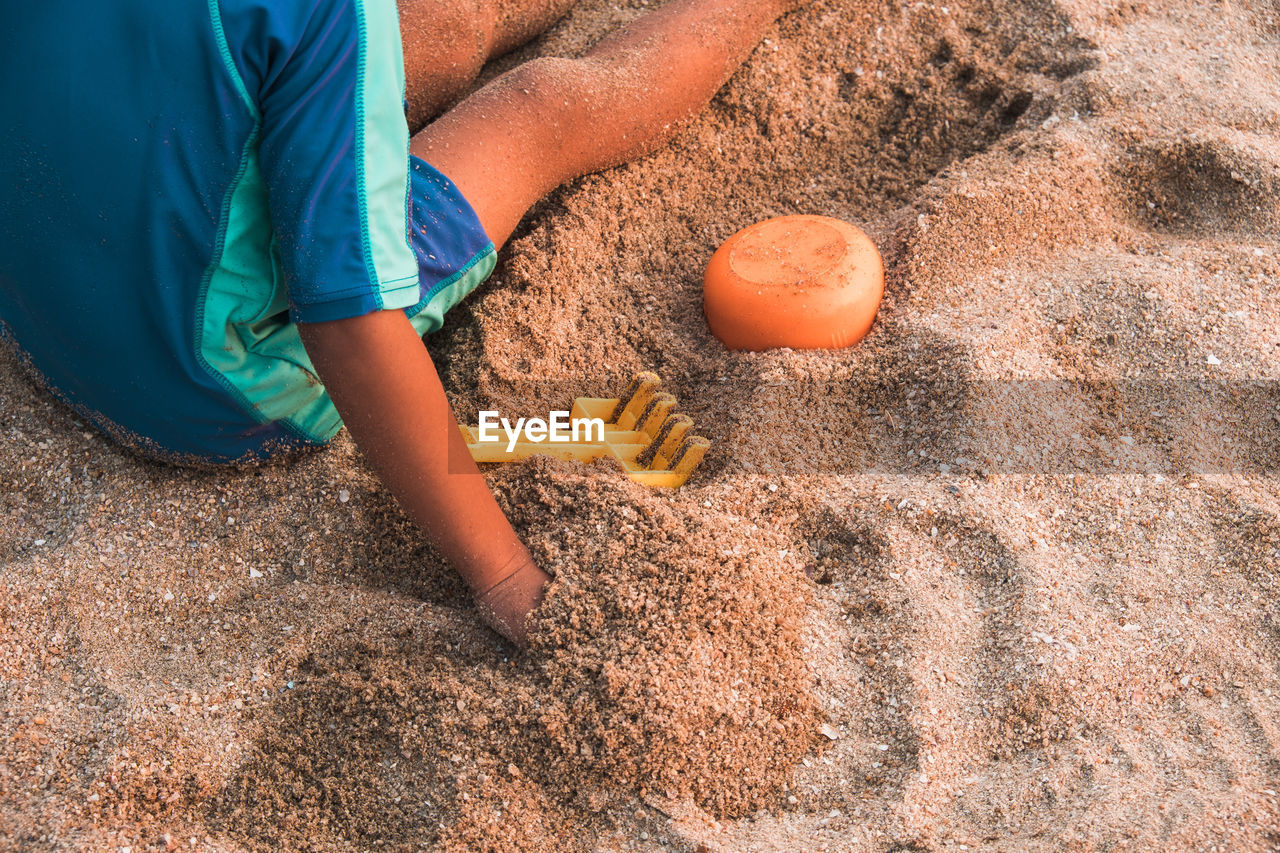 High angle view of playing on sand at beach