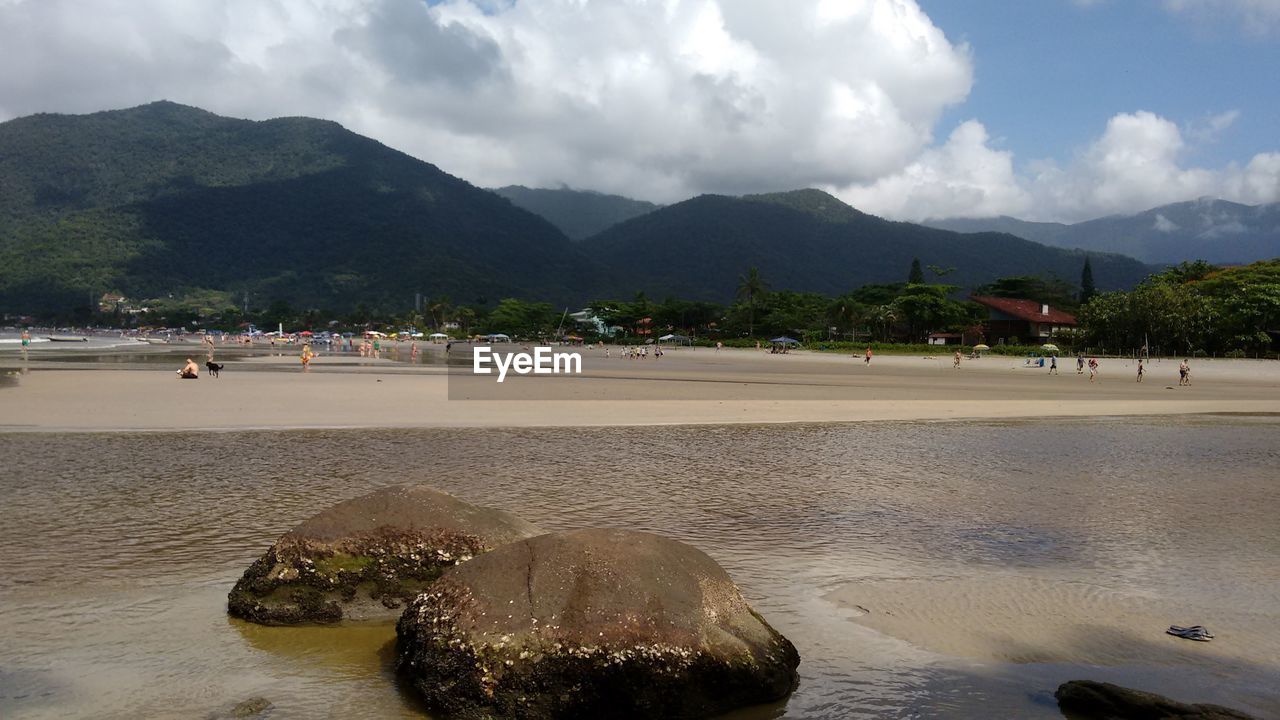 VIEW OF PEOPLE ON BEACH AGAINST SKY