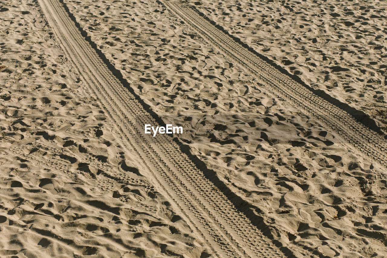 Close-up of tire tracks on sand