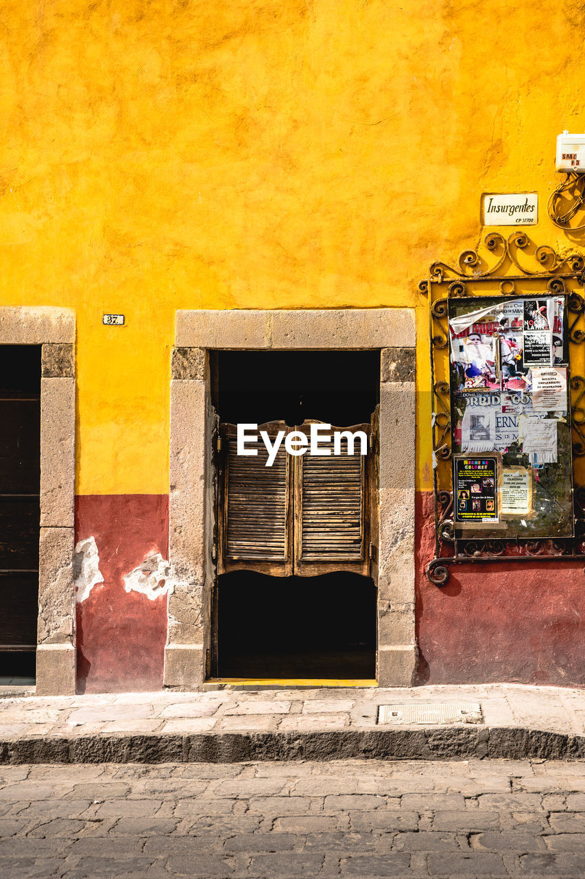 ENTRANCE OF BUILDING WITH YELLOW WALL