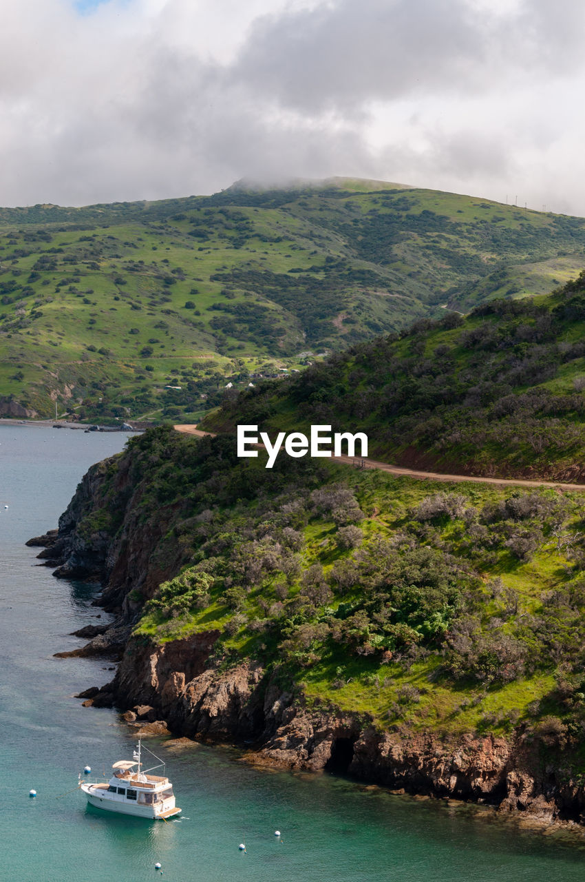 Scenic view of sea and mountains against sky