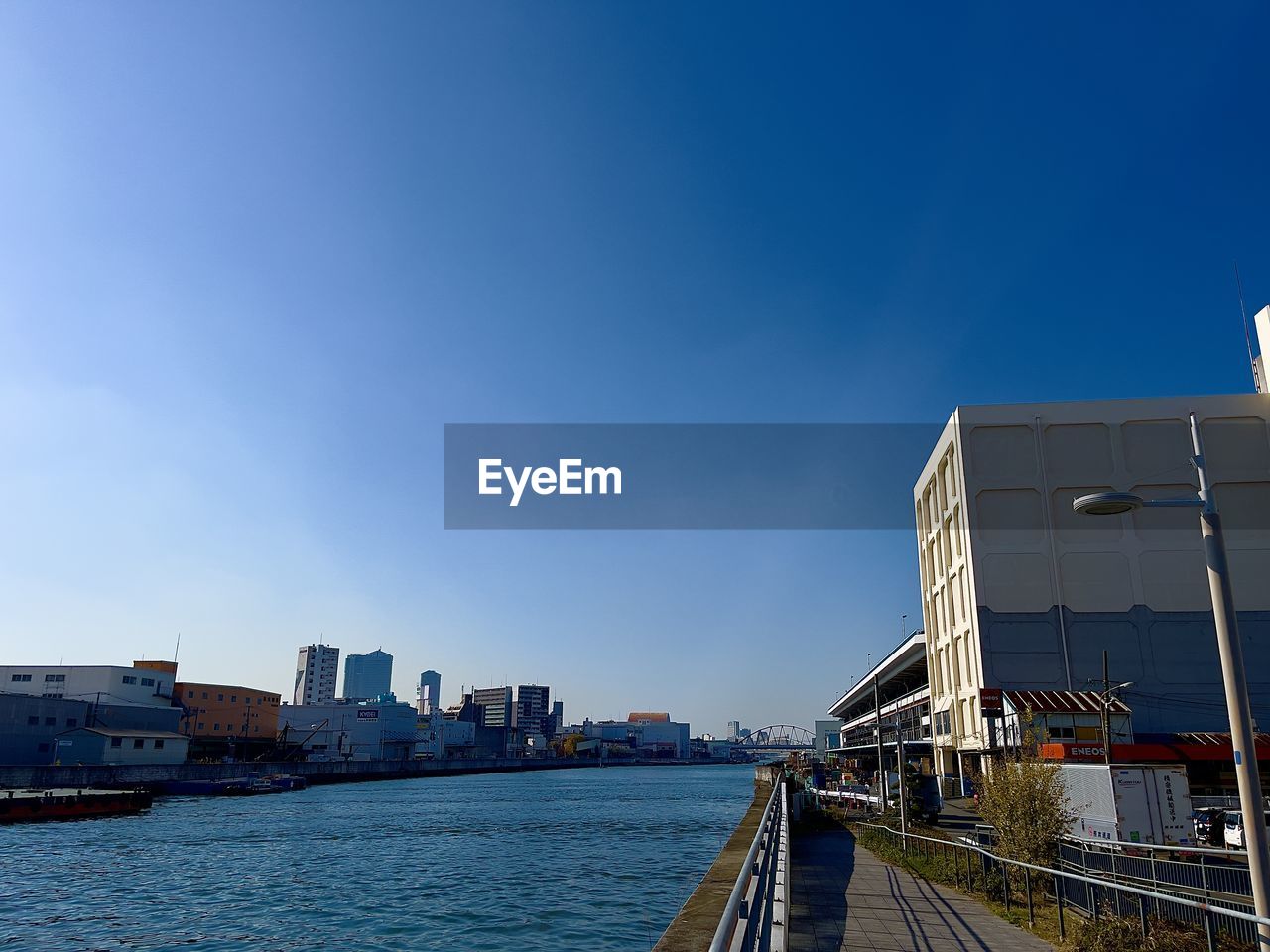 architecture, built structure, sky, building exterior, city, water, cityscape, transportation, building, nature, sea, skyline, blue, travel destinations, vehicle, harbor, travel, skyscraper, reflection, ship, no people, horizon, clear sky, office building exterior, landmark, urban area, bridge, outdoors, urban skyline, mode of transportation, waterway, copy space, day, landscape, city life, nautical vessel, coast, transport, dock, tourism