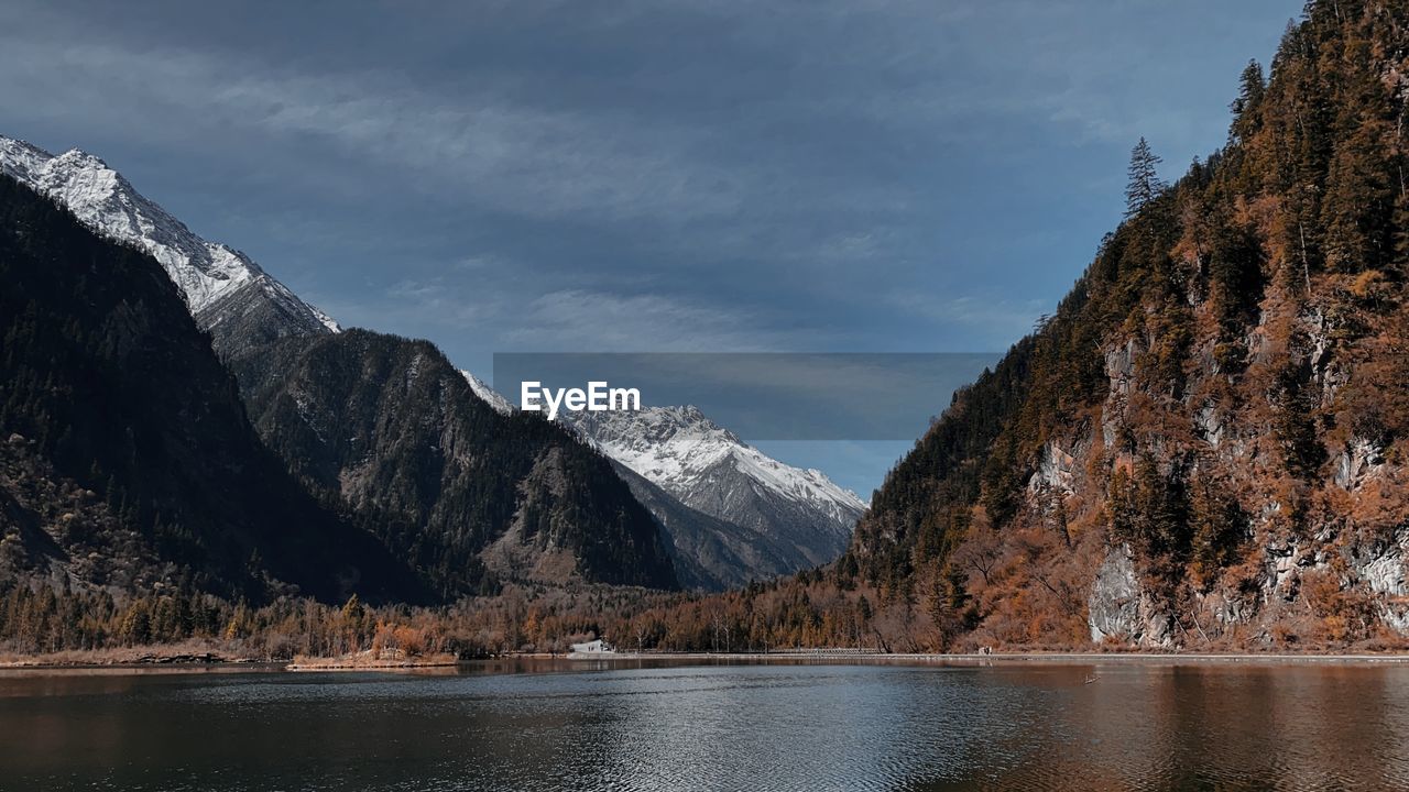 Scenic view of lake and mountains against sky