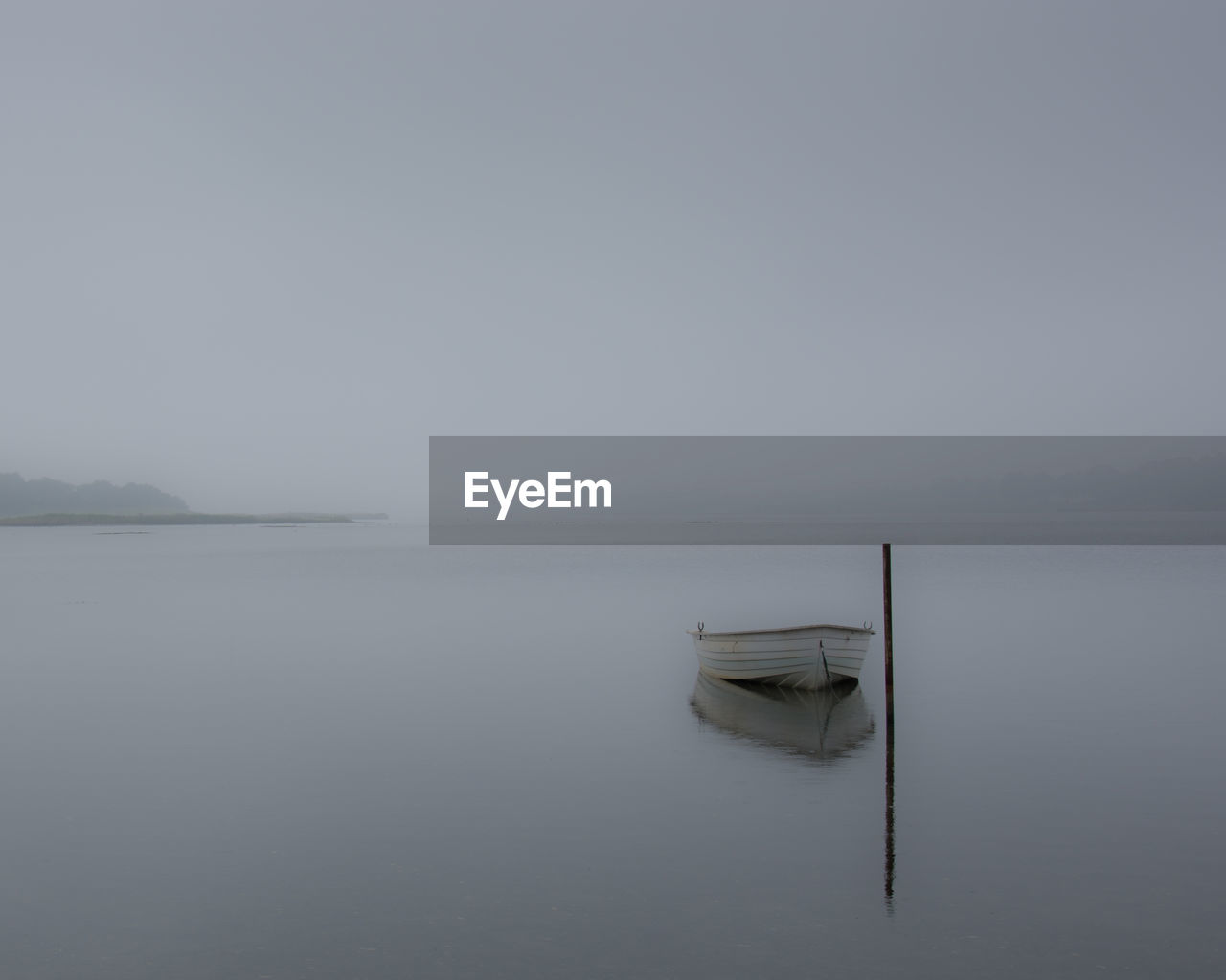 Scenic misty view of lake against sky