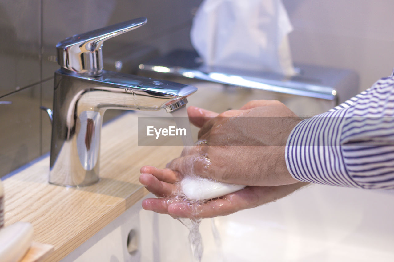 Midsection of man washing hands