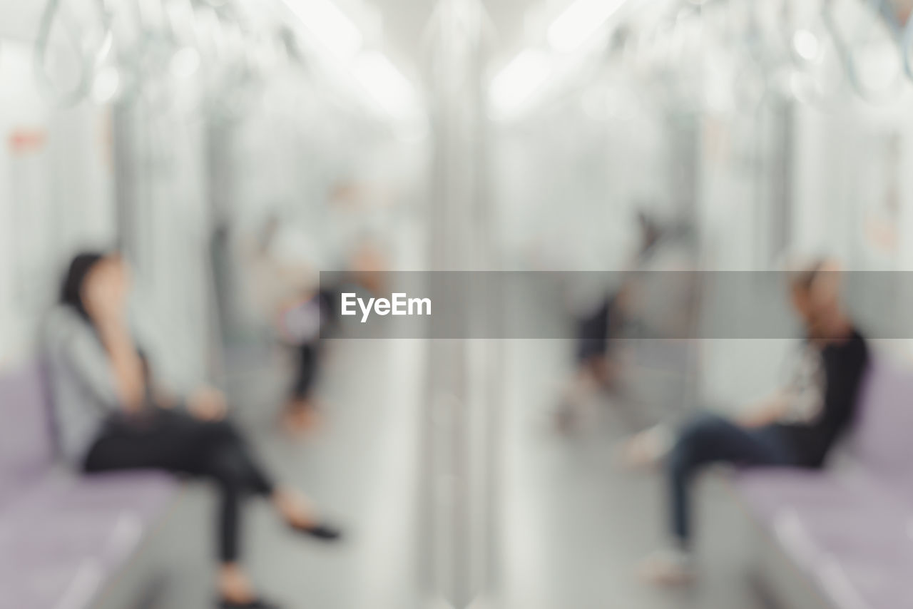 DEFOCUSED IMAGE OF PEOPLE WALKING IN CORRIDOR