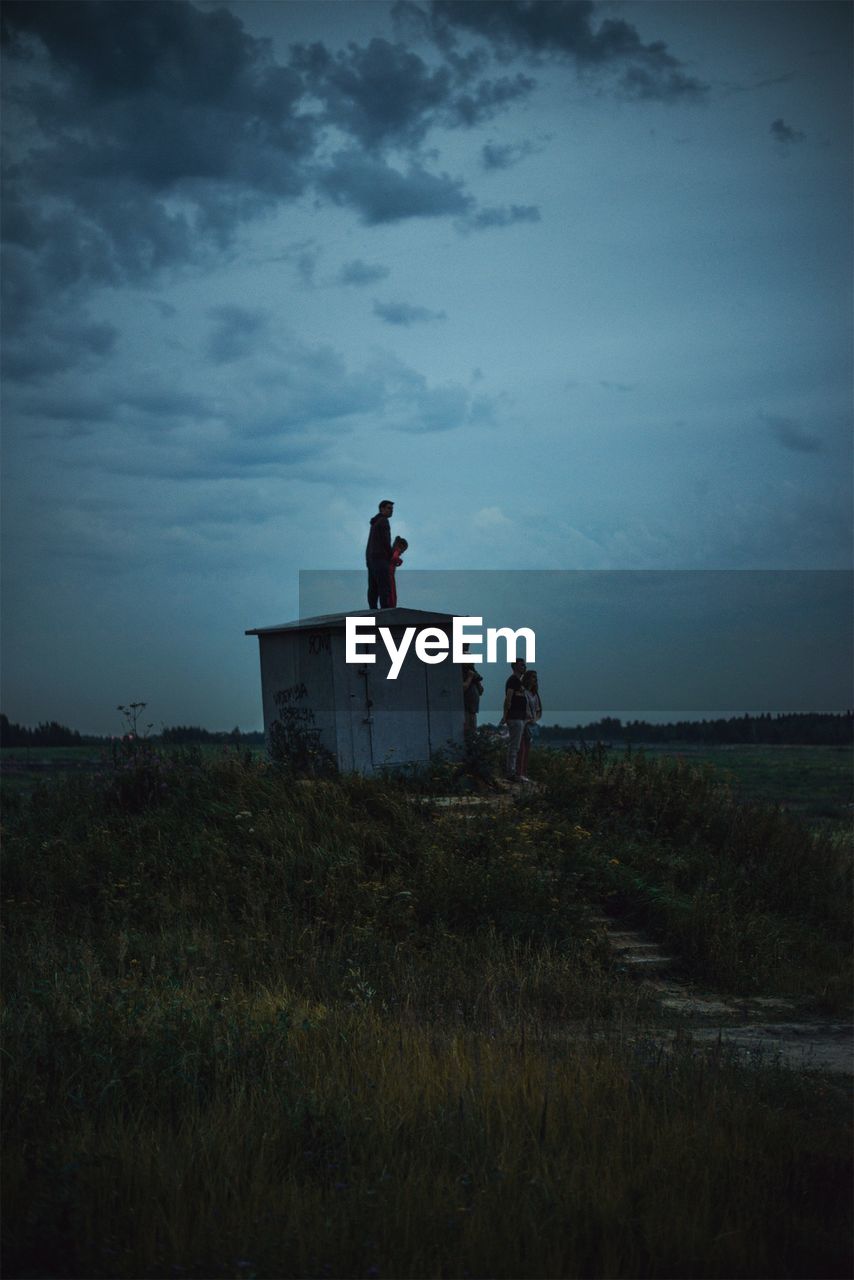 People standing by built structure against sky