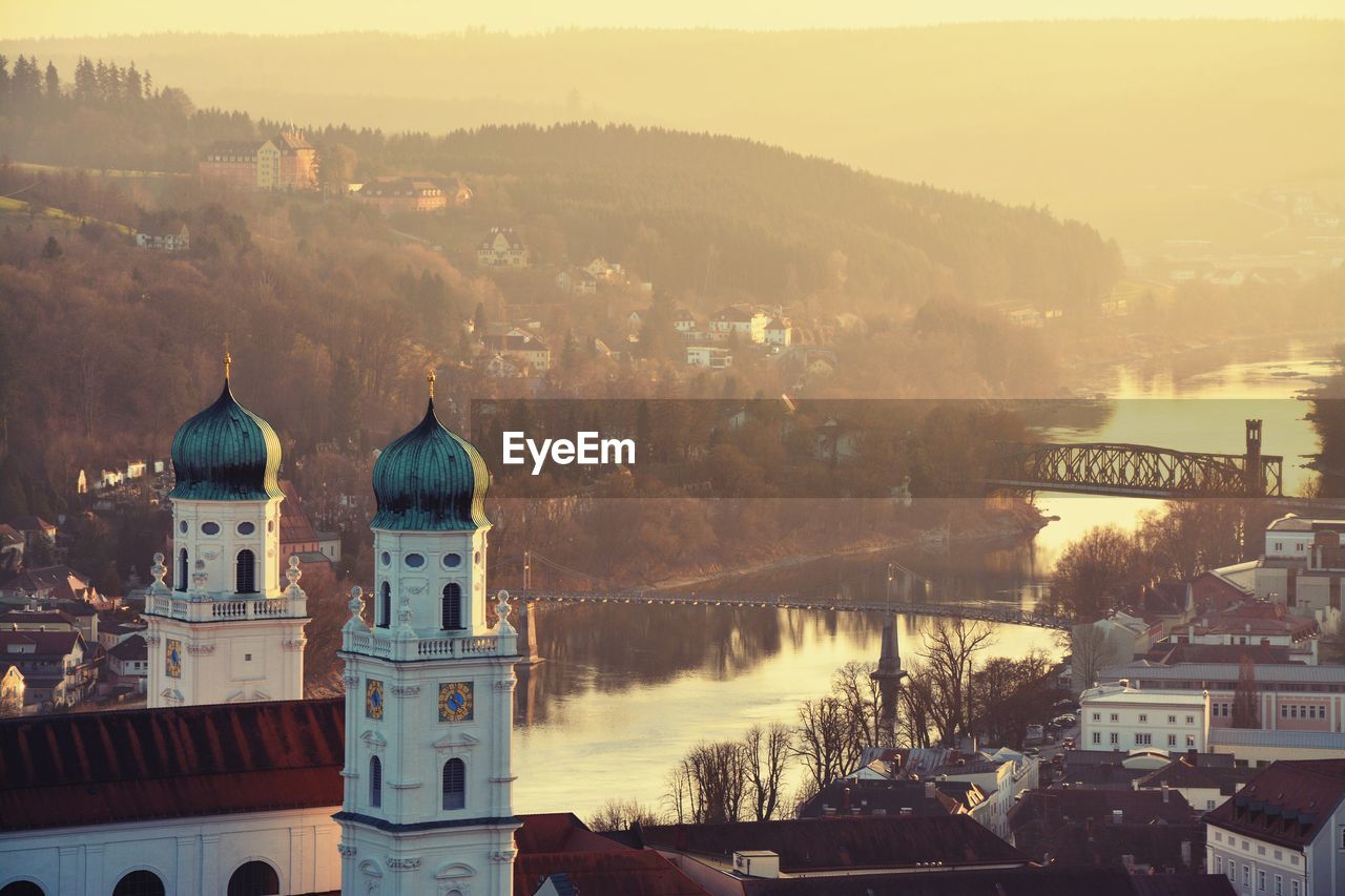 St stephen cathedral by inn river in passau during sunset