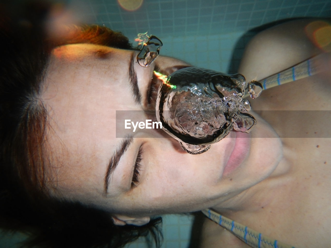 Directly above view of woman swimming underwater in pool