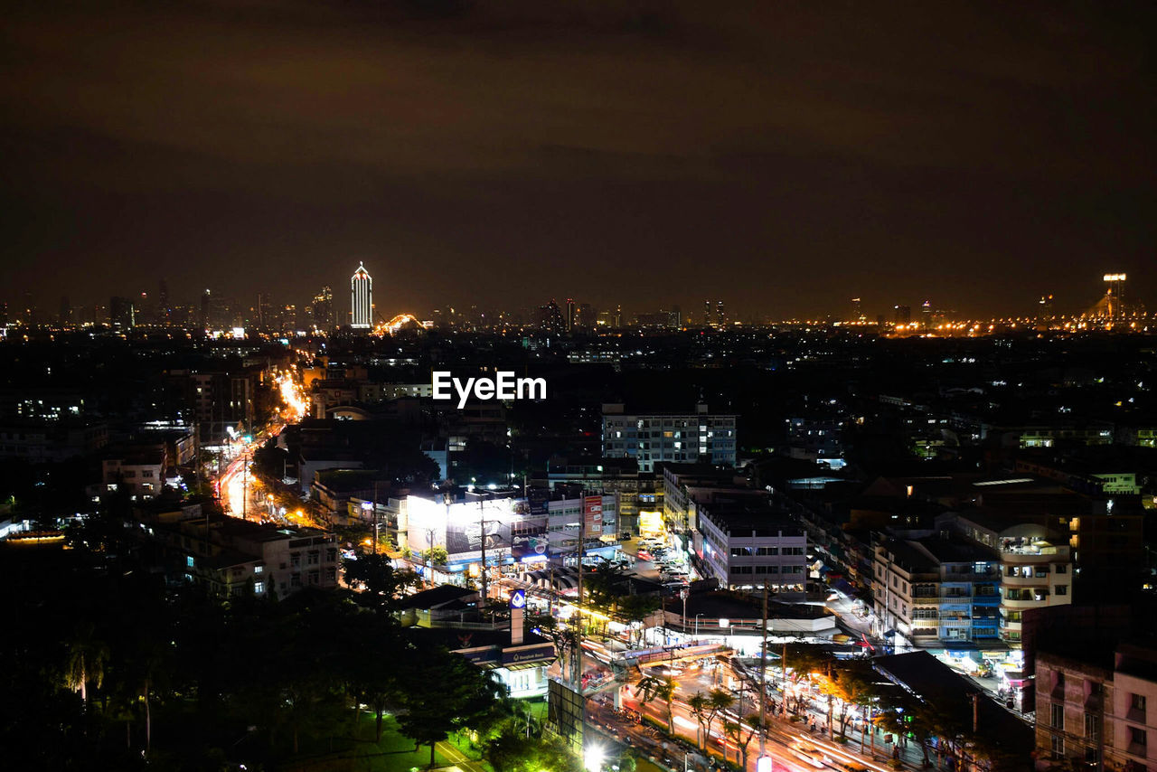 Aerial view of city lit up at night