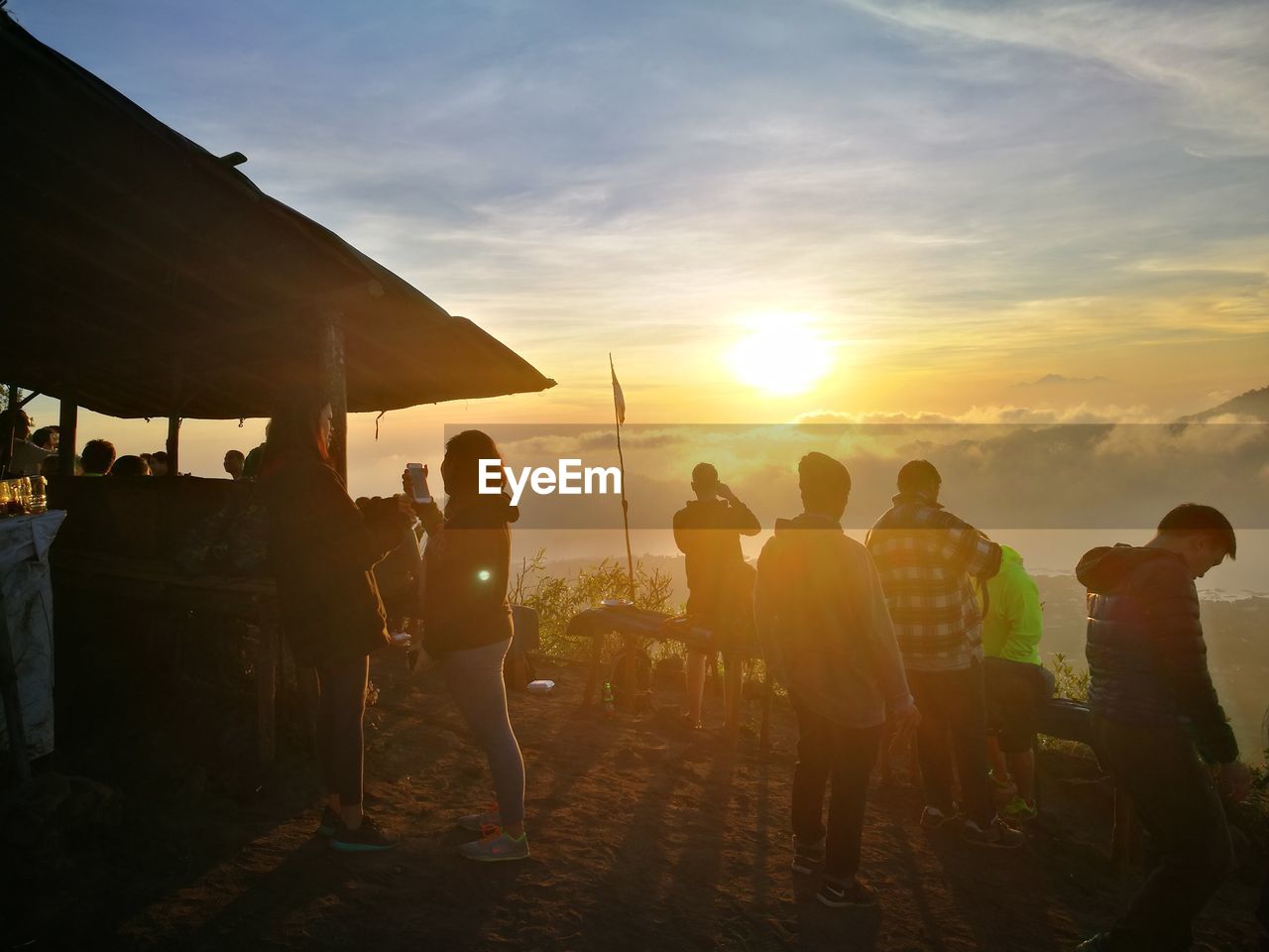 PEOPLE STANDING AT SUNSET