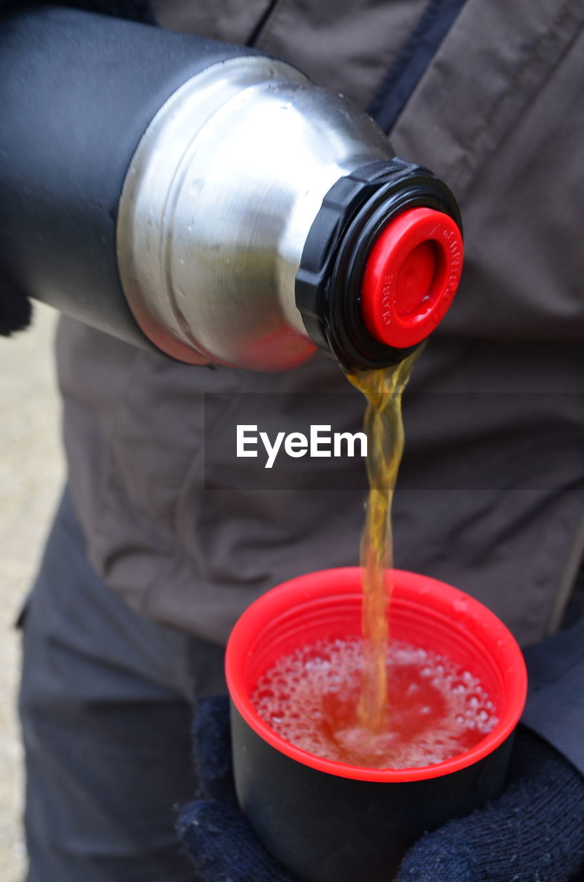 MIDSECTION OF MAN DRINKING GLASS