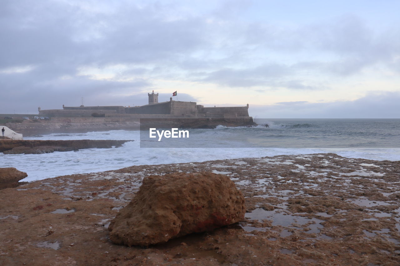 VIEW OF ROCKS ON BEACH AGAINST SKY