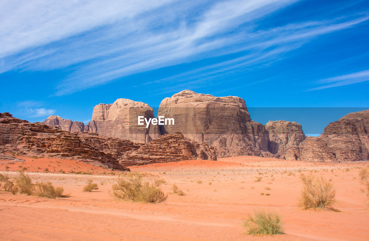 Rock formations in desert against blue sky