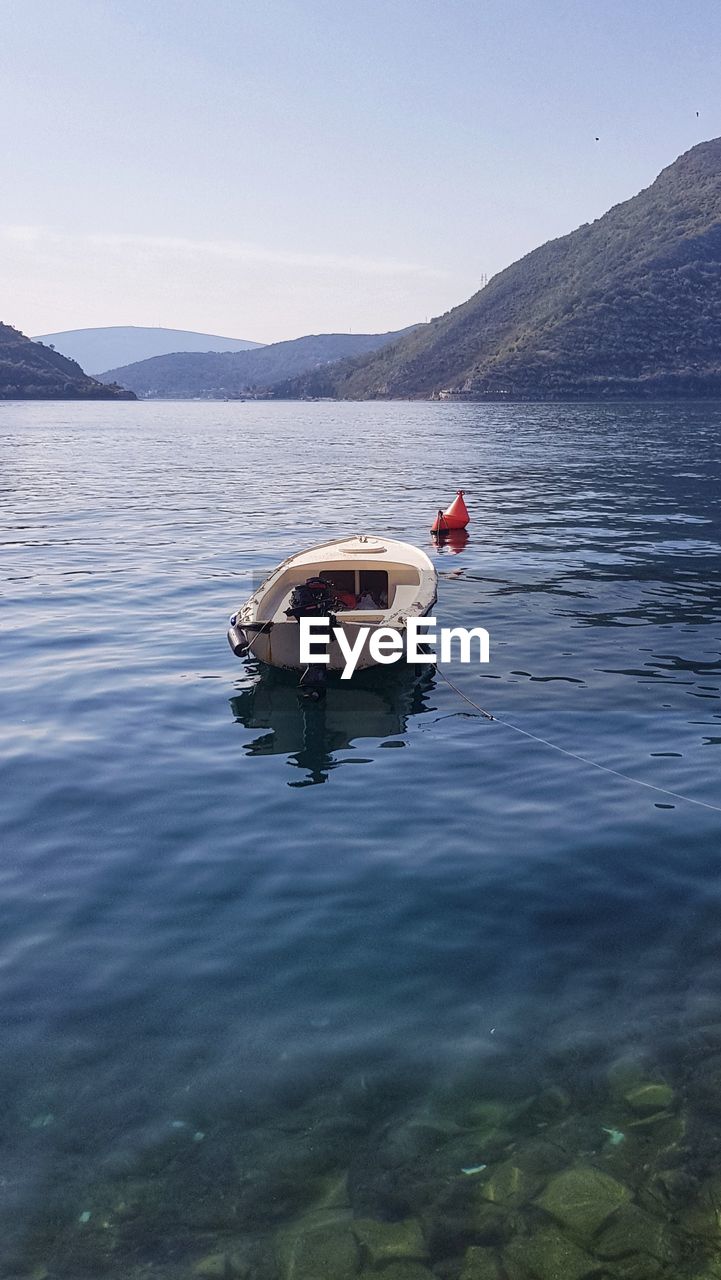 Boat in lake against sky