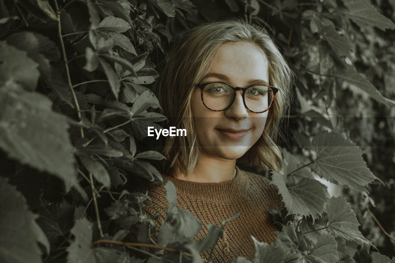 Close-up portrait of young woman in eyeglasses