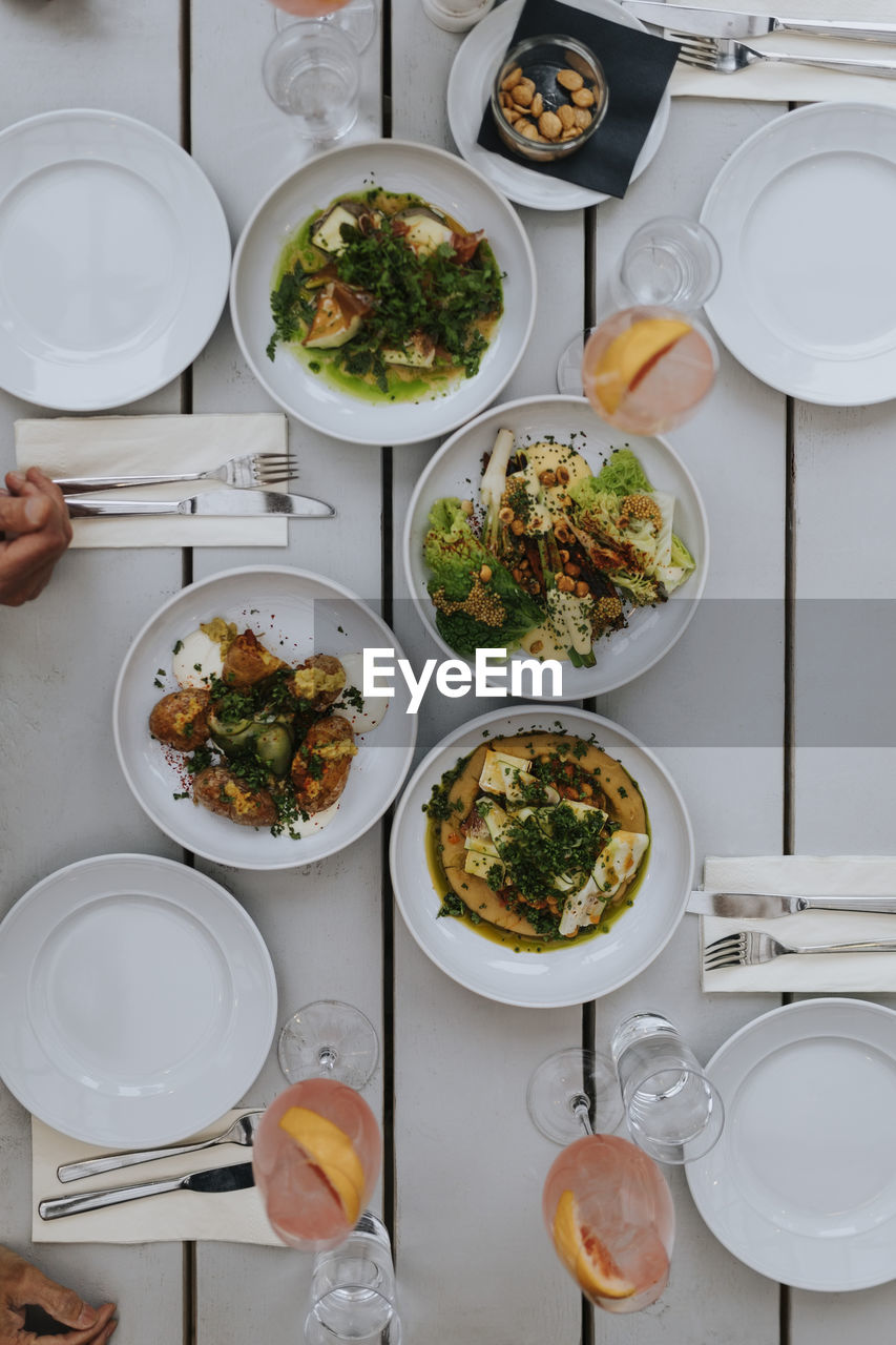 Directly above shot of food and drinks on table at restaurant