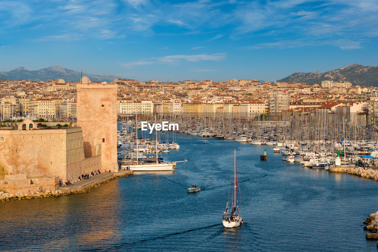 Yachts coming to marseille old port on sunset. marseille, france