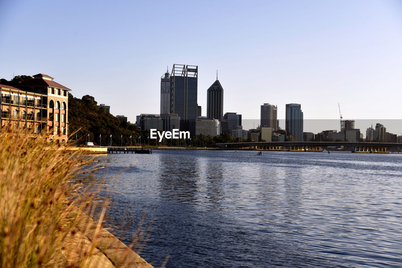 City at waterfront during sunset