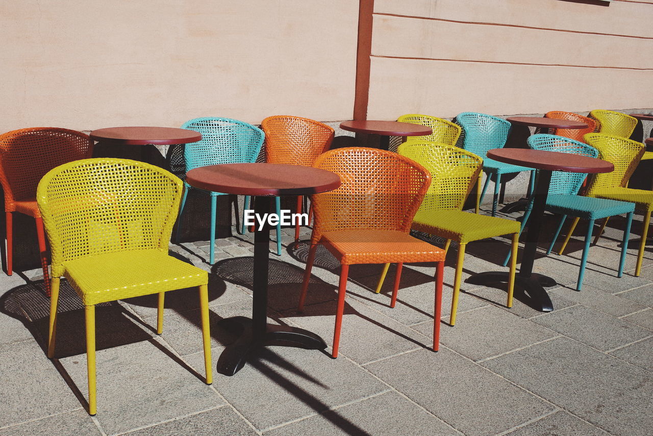 Empty tables and chairs at outdoor cafe