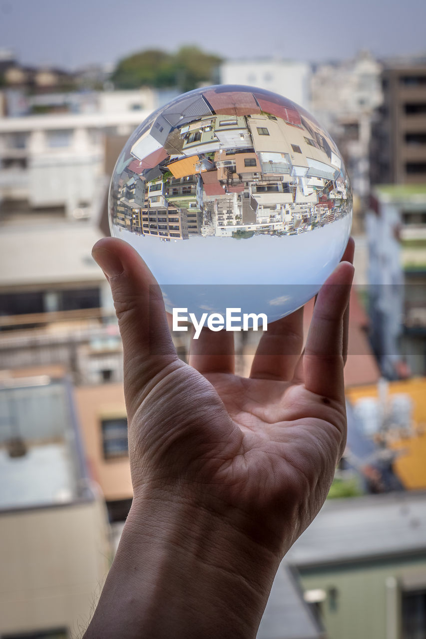 cropped hand of person holding crystal ball