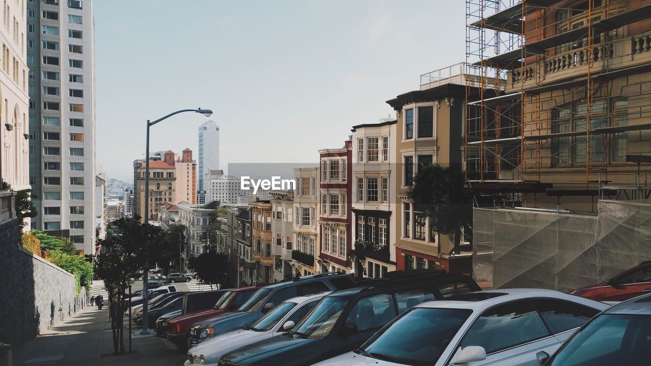 Cars parked by buildings in city