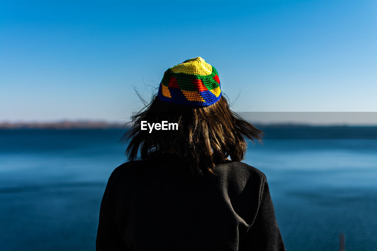 Rear view of woman looking at sea against sky