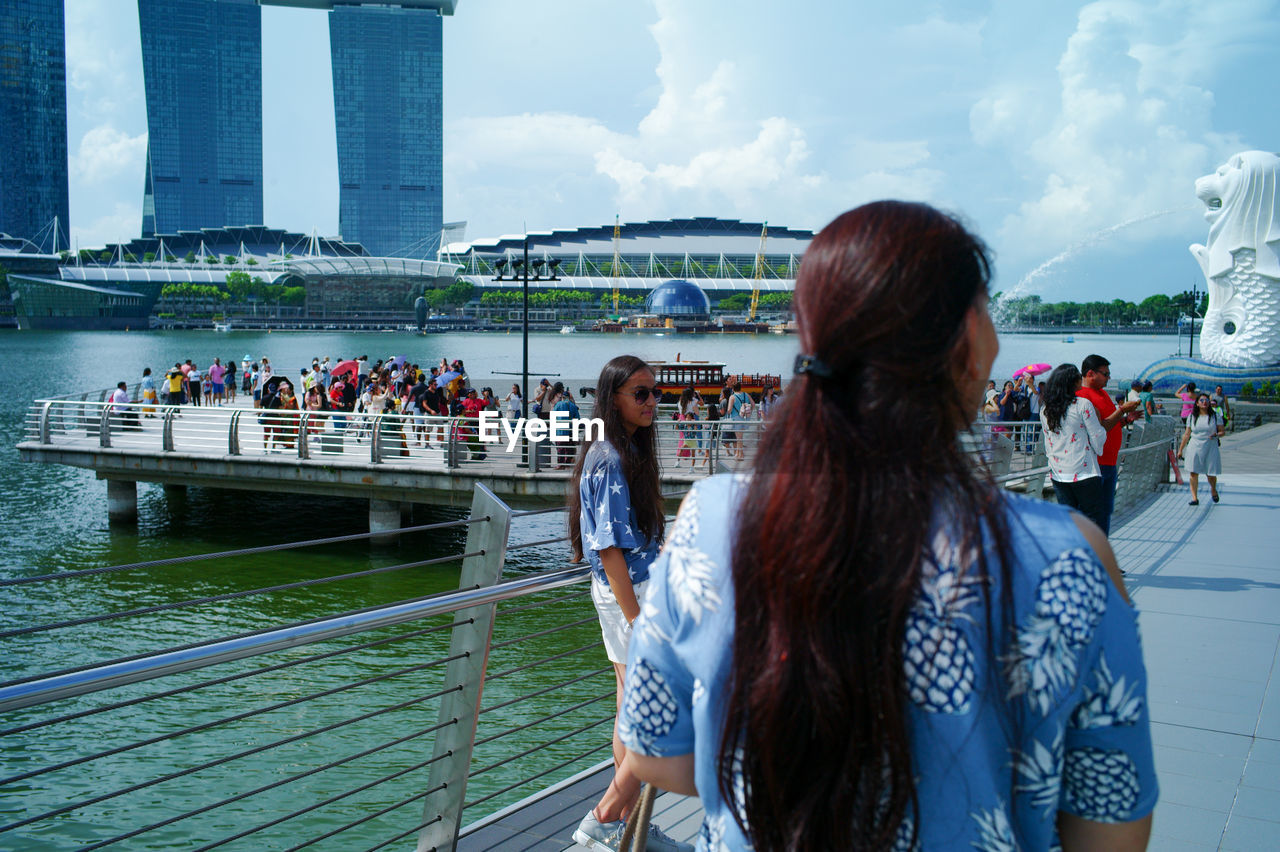 WOMAN LOOKING AT VIEW OF BRIDGE