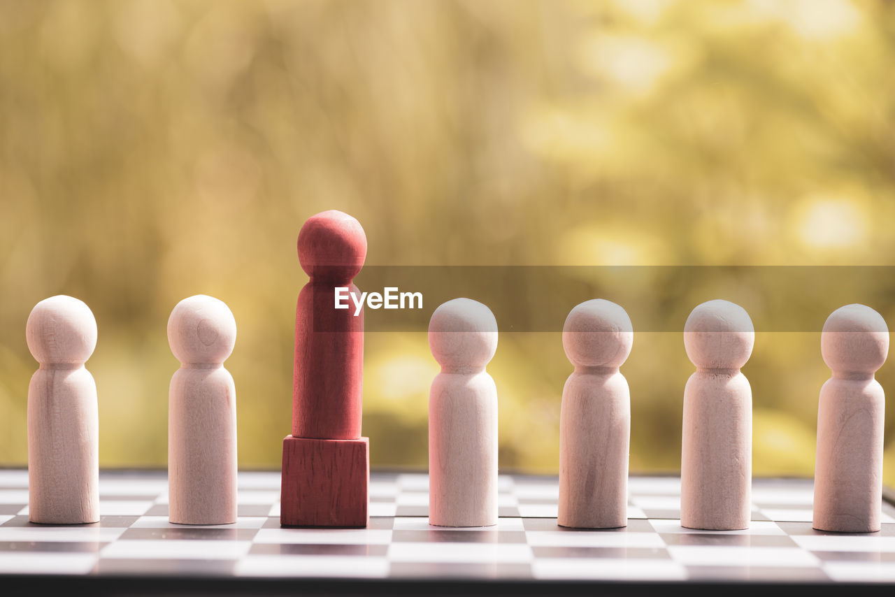 close-up of chess pieces on wooden table