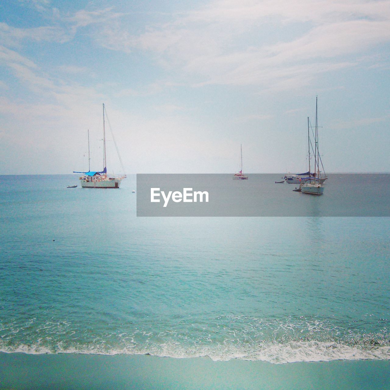 View of boats in calm blue sea