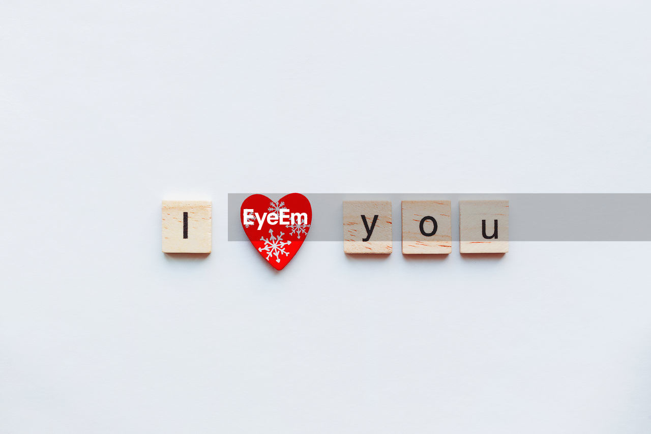 studio shot, indoors, love, heart shape, text, positive emotion, copy space, western script, red, no people, font, white background, communication, game, emotion, still life, alphabet, letter, indoor games and sports, group of objects, close-up