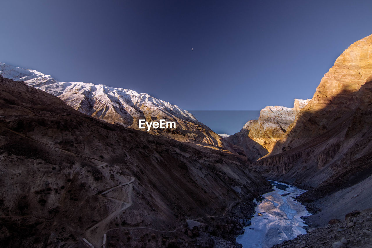 Snowcapped mountain peak against clear sky