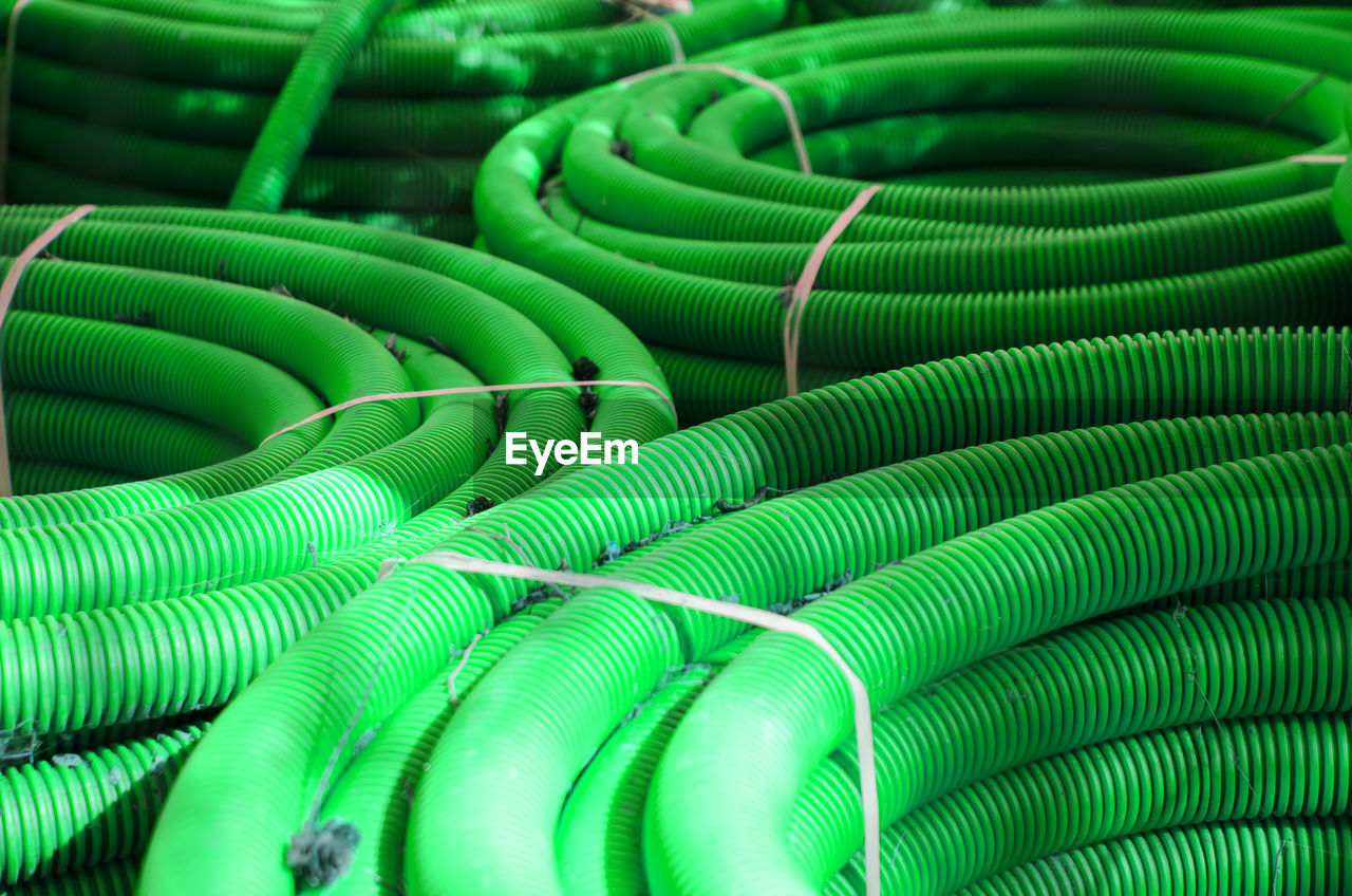 Many bundles of plastic water pipes green color.
